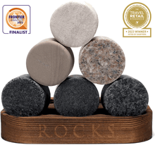 Unique granite whiskey chilling stones in a stylish wooden holder, perfect for cooling spirits without dilution.