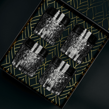 Set of 4 luxury whiskey glasses displayed in elegant gift box, perfect for cocktail enthusiasts.