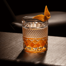 Elegant whiskey glass with cocktail garnish, perfect for sophistication and style in your drinkware collection.