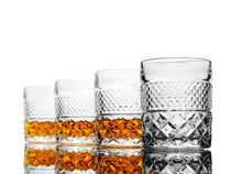 Four whiskey glasses displaying amber-colored whiskey, ideal for serving bourbon or scotch in style.