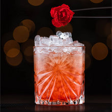 Elegant cocktail glass filled with ice and topped with a rose, perfect for whiskey or scotch. Ideal for barware enthusiasts.