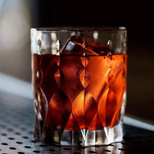 Stylish whiskey glass with bourbon and ice, perfect for cocktails and sophisticated barware.