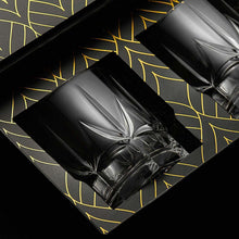Elegant whiskey glasses showcased in a luxurious black and gold gift box, ideal for barware enthusiasts.