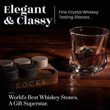 Elegant whiskey tasting glasses with granite chilling stones in a sophisticated setting.