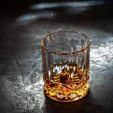 Elegant whiskey glass showcasing rich amber spirit, ideal for enjoying bourbon or scotch with chilling stones.