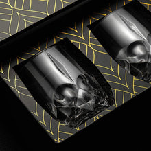 Set of two eco-crystal skull whiskey glasses in elegant packaging, perfect for gifts and barware.