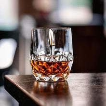 Eco-Crystal glass filled with whiskey on a wooden table, perfect for cocktail and barware enthusiasts.
