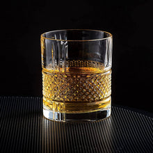 Elegant Reserve Crystal whiskey glass with whiskey, perfect for chilling stones and sophisticated cocktail experiences.