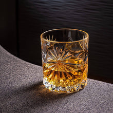 Stylish crystal whiskey glass filled with rich amber scotch, highlighting luxury barware for cocktails and gifts for men.